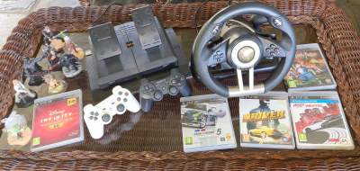 Play station 3 with controllers, driving wheel, and games. - All Informatics Products